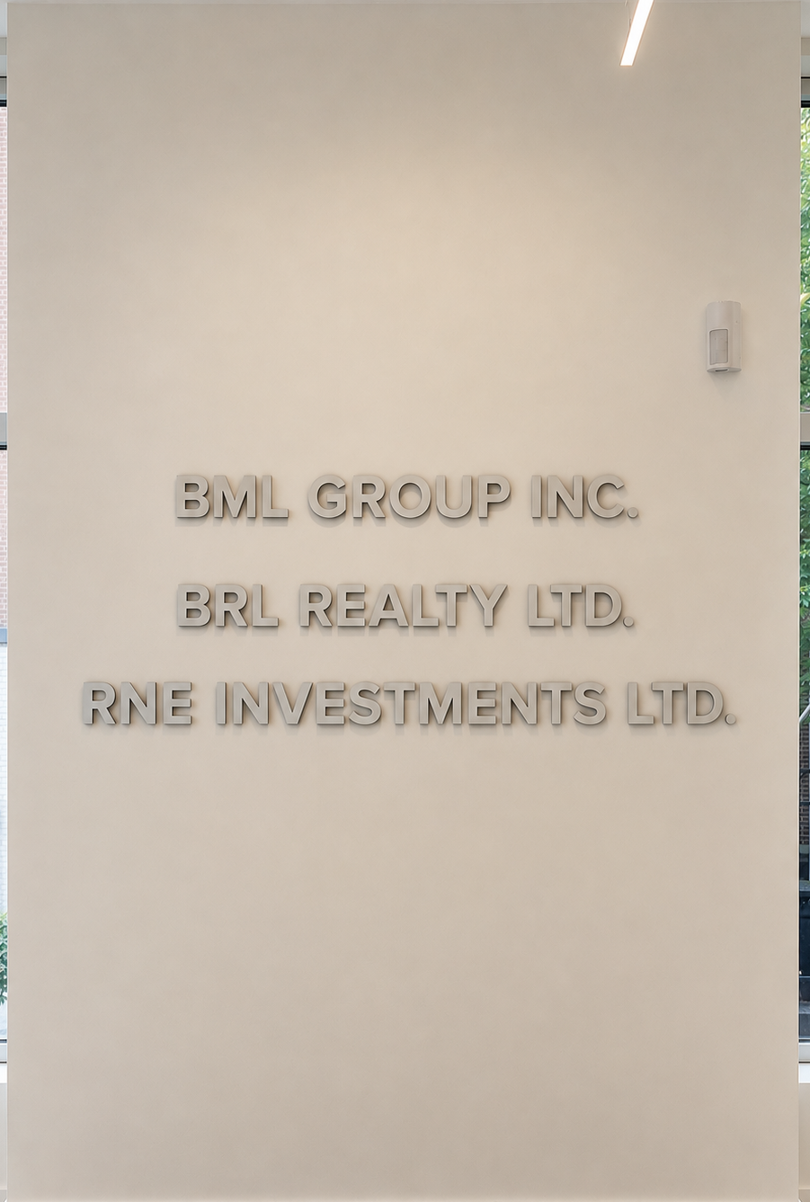 BML Group office lobby wall showing BML Group Inc., BRL Realty Ltd. and RNE Investments Ltd.